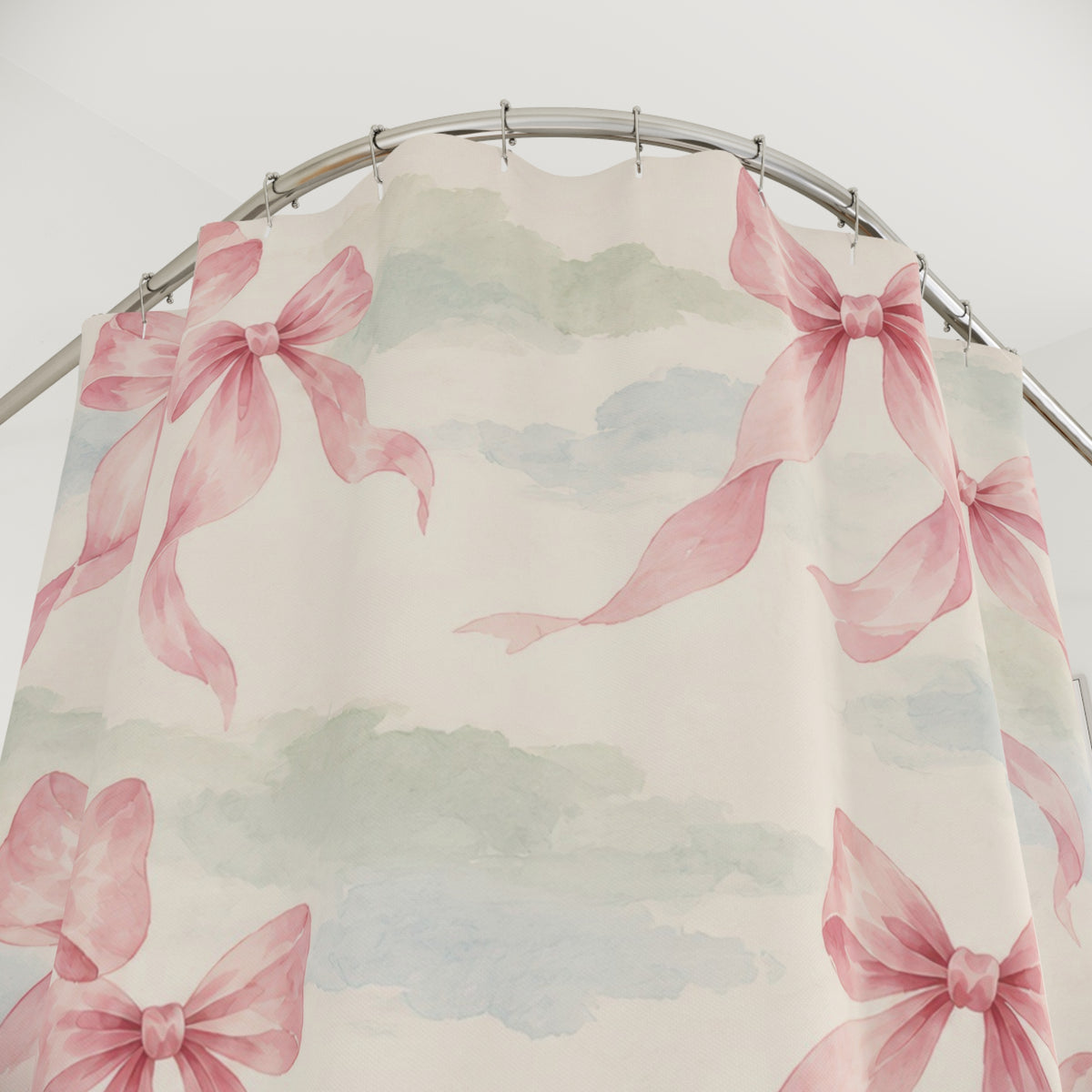 Pink bow pairs over pale sage and dusty blue washes shower curtain with close-up print, hooks, and folds