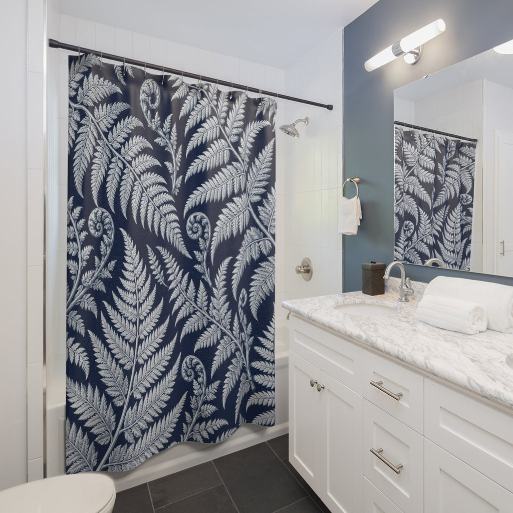 White fern fronds and curled fiddleheads on deep navy shower curtain beside a white vanity