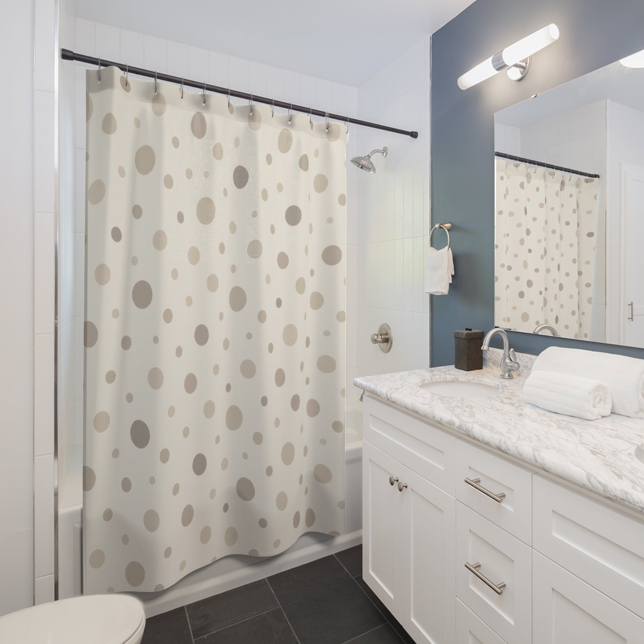 Neutral cream and taupe organic polka dots shower curtain beside a white vanity