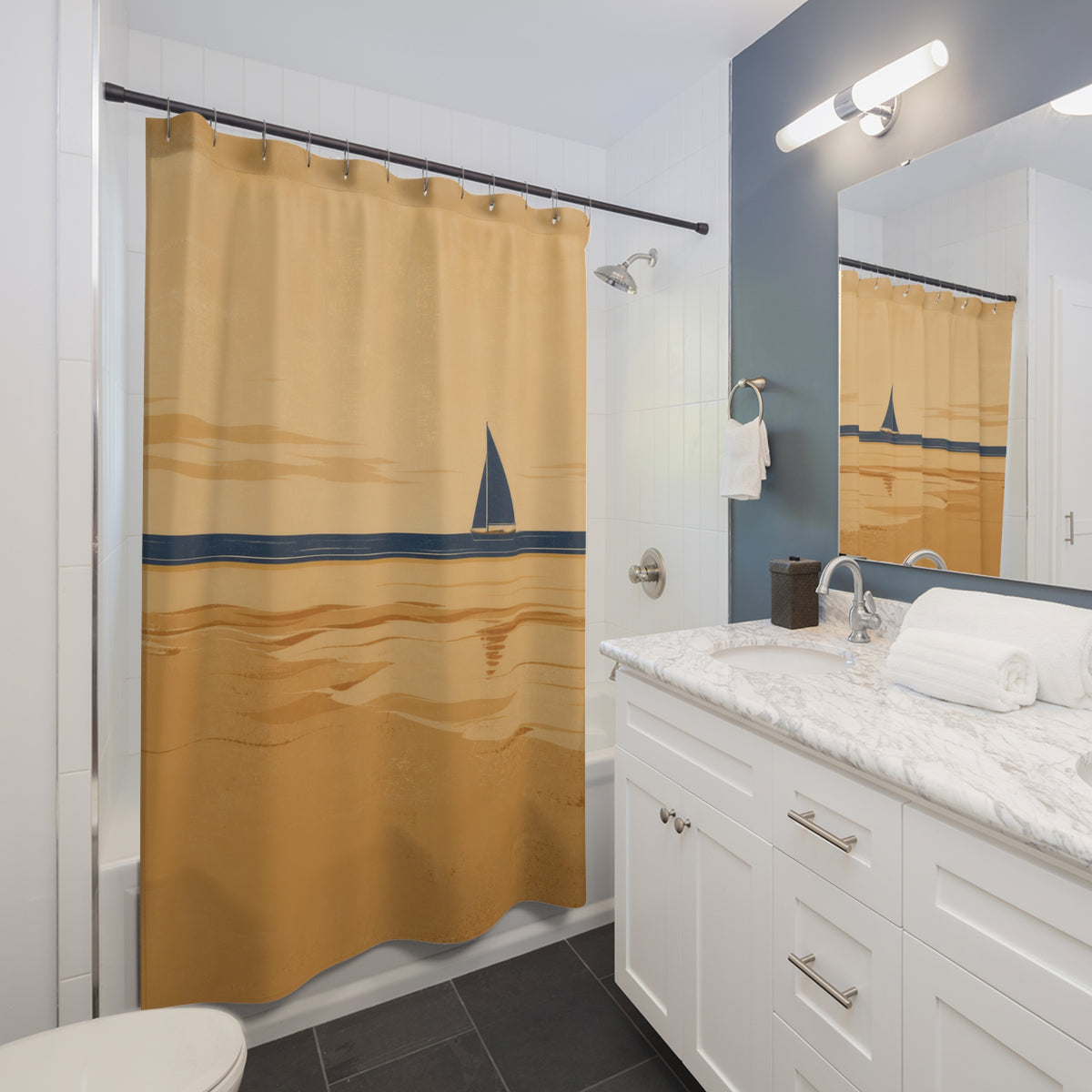Navy sailboat crossing a broad tan sandbar under a warm sky shower curtain beside a white vanity