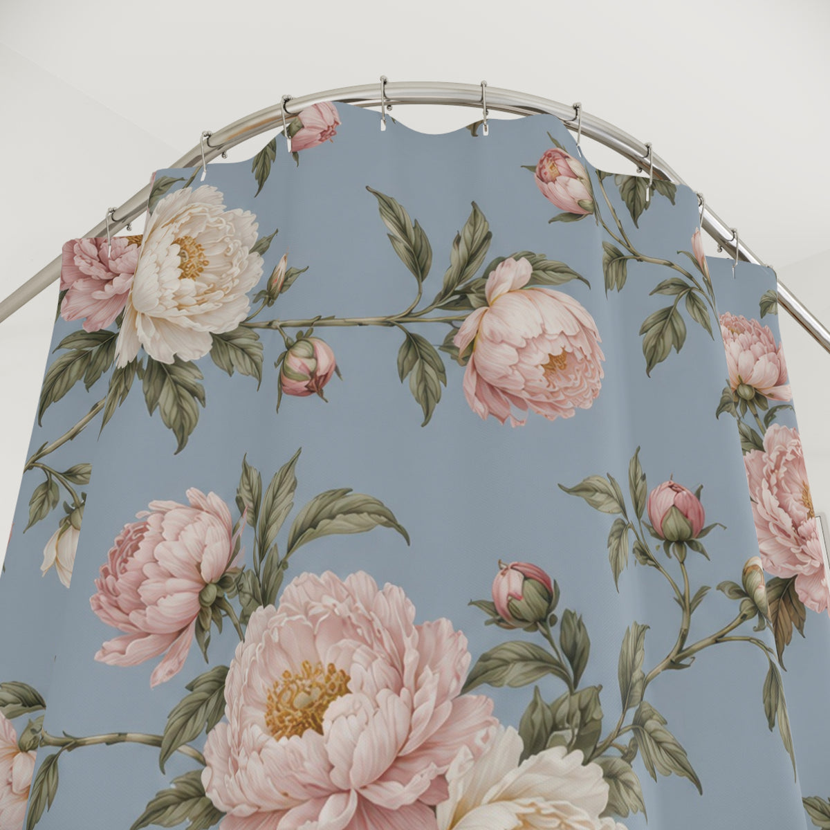 Blush and ivory peonies on dusty blue shower curtain with close-up print, hooks, and folds