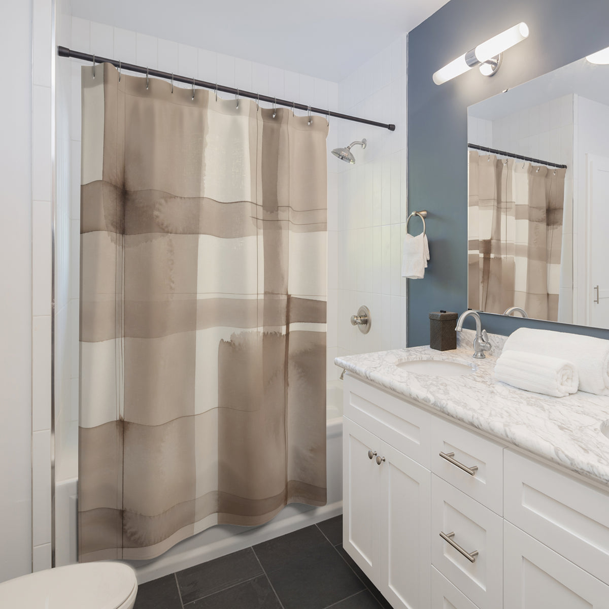 Oversized taupe watercolor windowpane check pattern shower curtain beside a white vanity