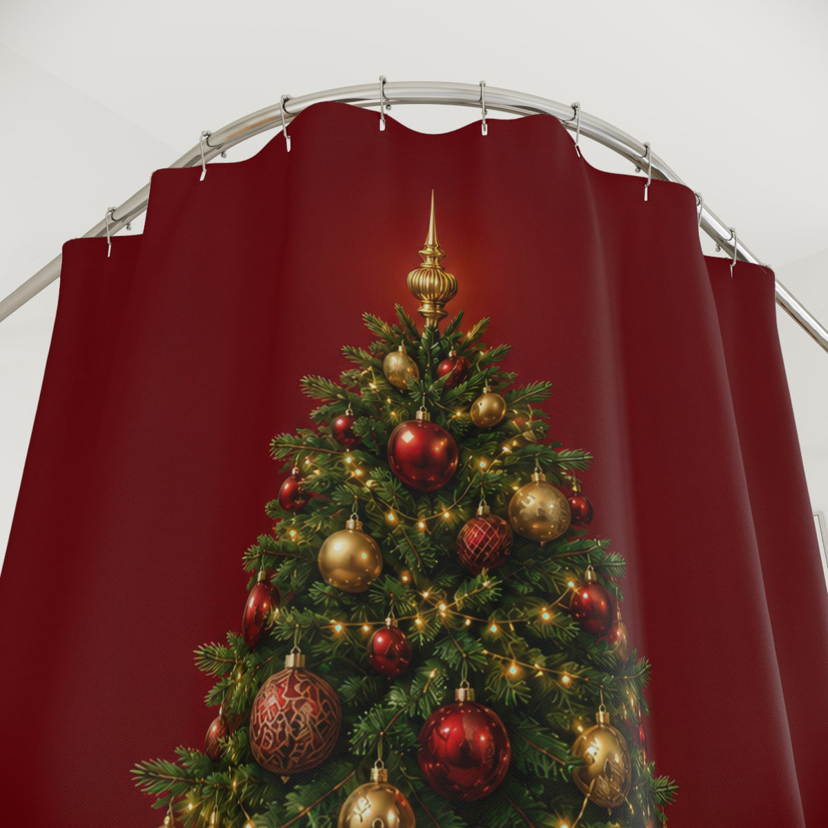 Green Christmas tree with gold baubles on garnet red shower curtain with close-up print, hooks, and folds