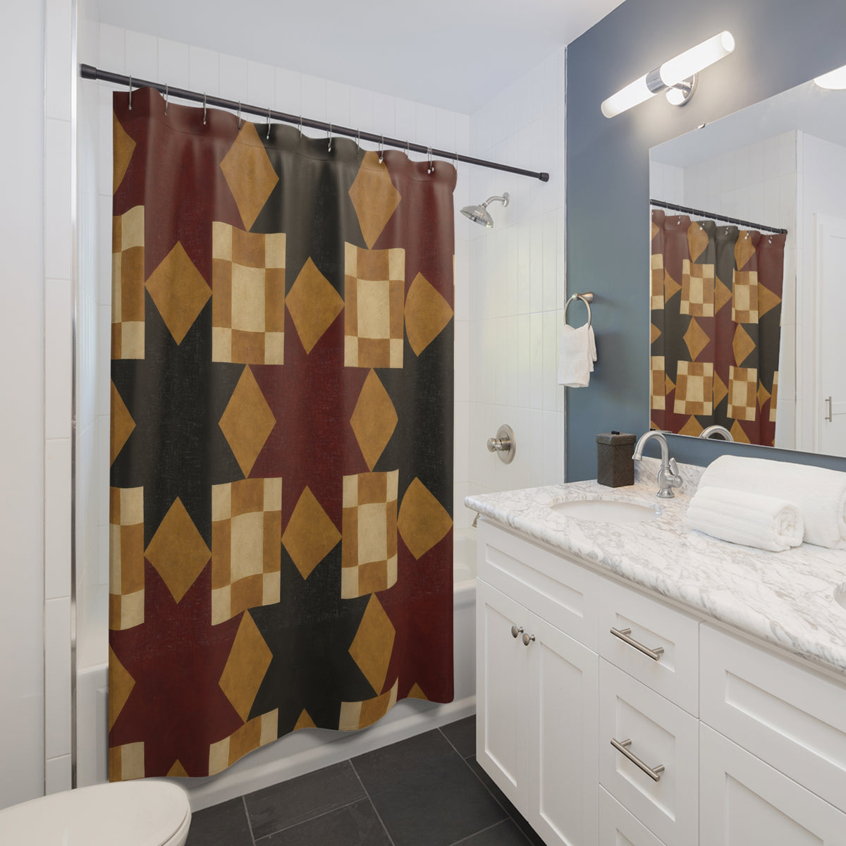 Burgundy and charcoal stars with mustard and cream blocks shower curtain beside a white vanity