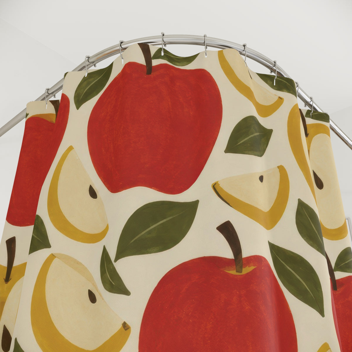 Red apples and yellow apple halves with olive leaves shower curtain with close-up print, hooks, and folds