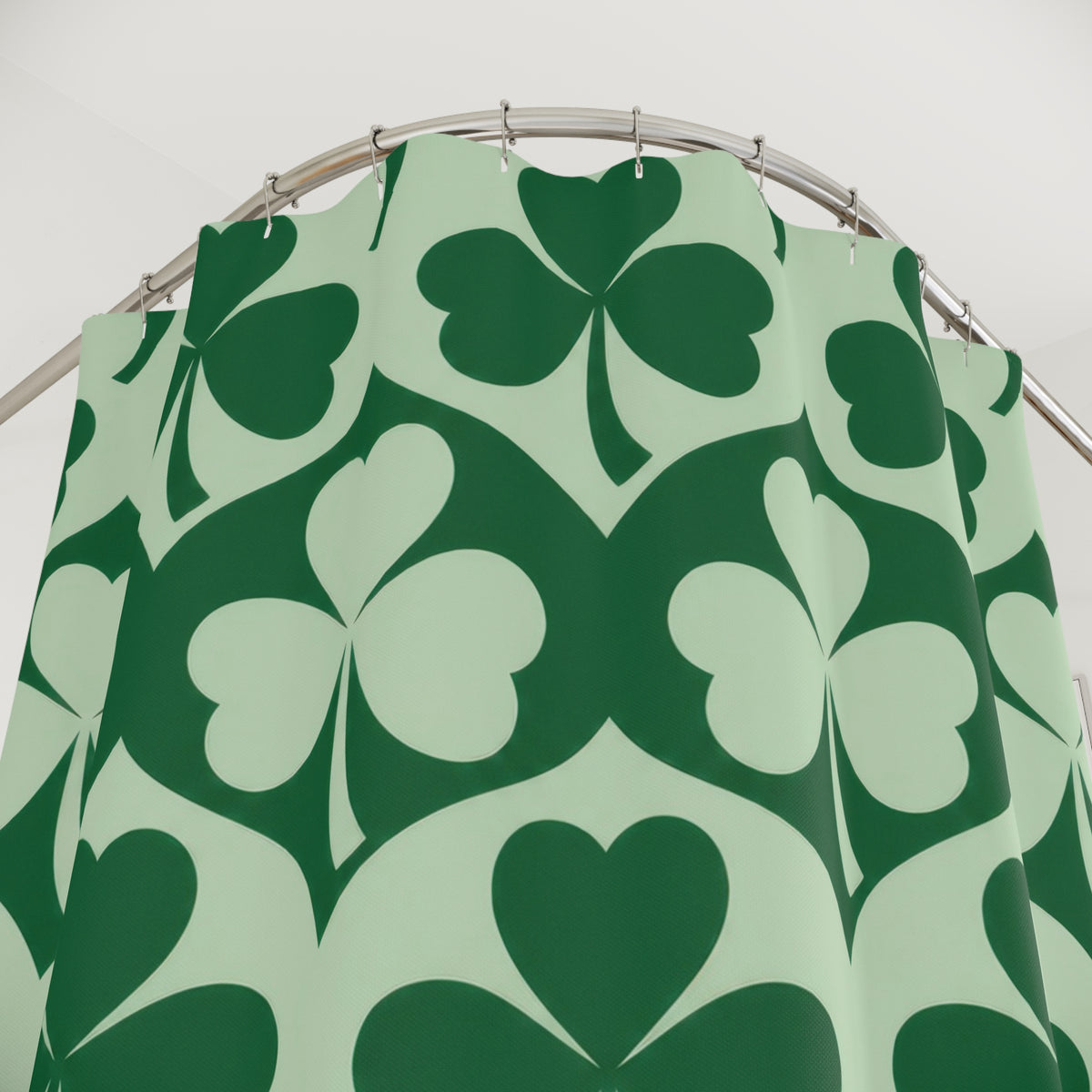 Emerald and mint green shamrock pattern shower curtain with close-up print, hooks, and folds
