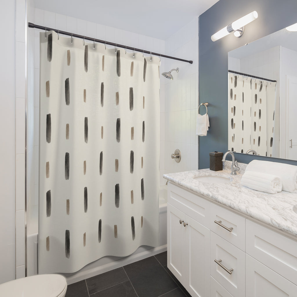 Charcoal and taupe ink dashes in spaced rows on ivory shower curtain beside a white vanity