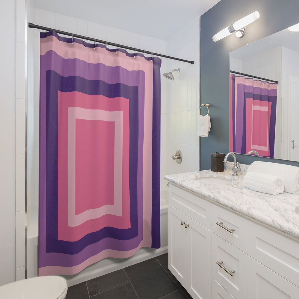 Nested rectangular stripes in pink, orchid and deep violet shower curtain beside a white vanity