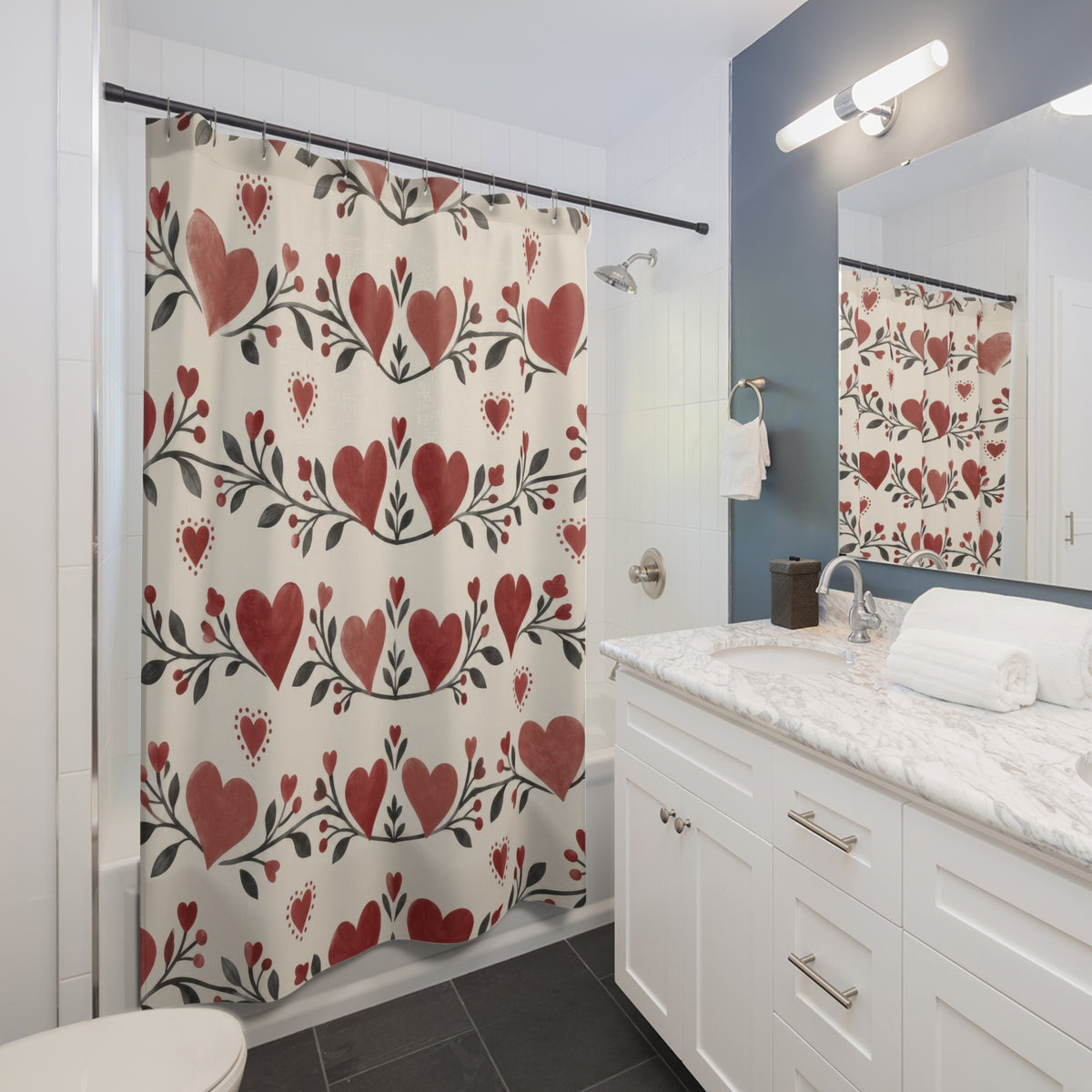 Red and rose hearts with charcoal leaves shower curtain beside a white vanity