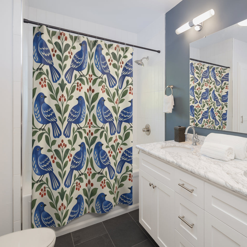 Cobalt birds, green leaves and red berries on ivory shower curtain beside a white vanity