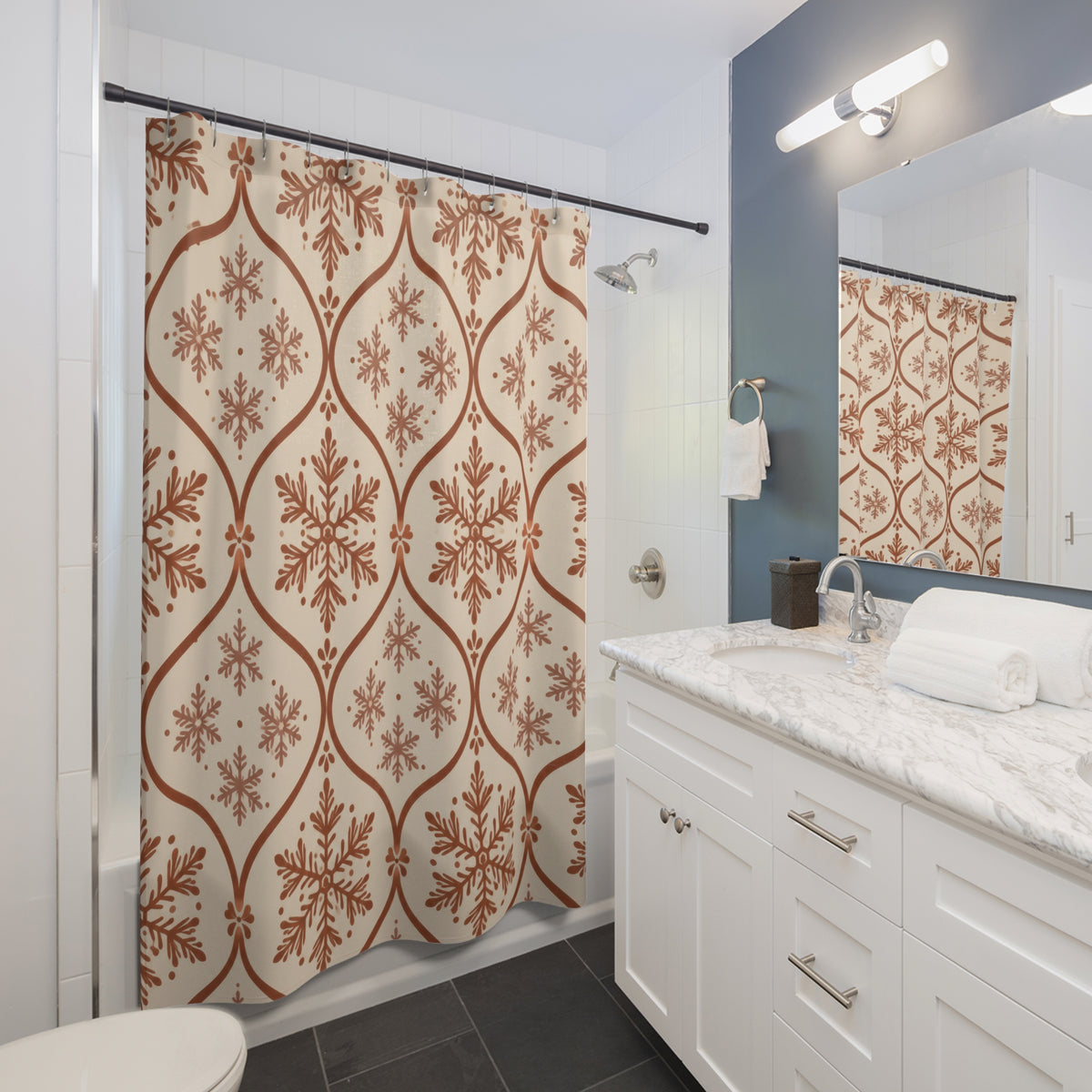 Cinnamon rust snowflakes in an ogee trellis on cream shower curtain beside a white vanity