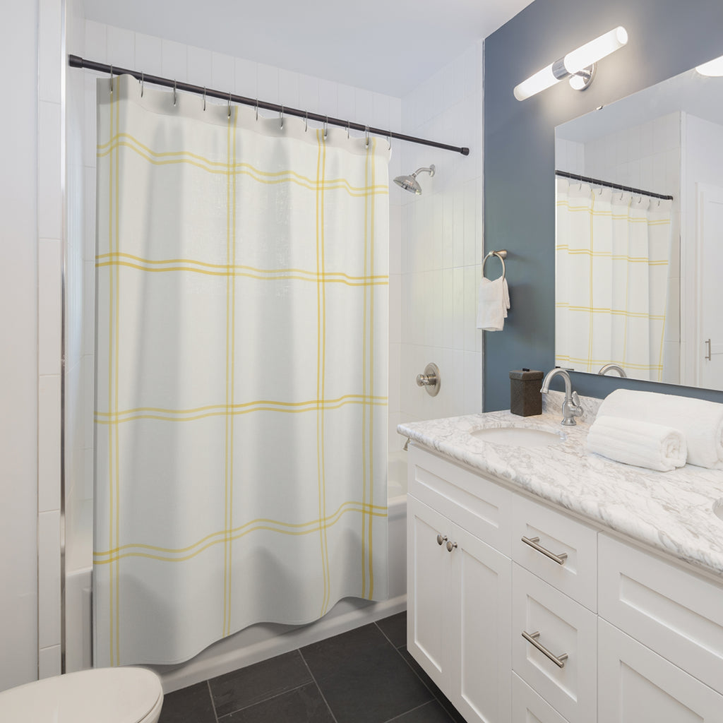 Pale lemon windowpane check on warm white shower curtain beside a white vanity
