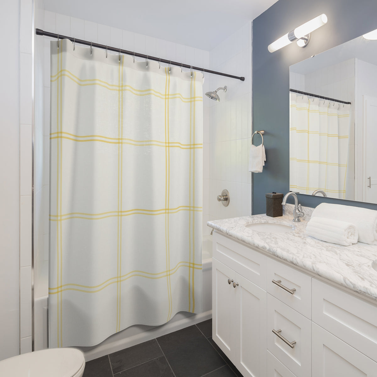 Pale lemon windowpane check on warm white shower curtain beside a white vanity