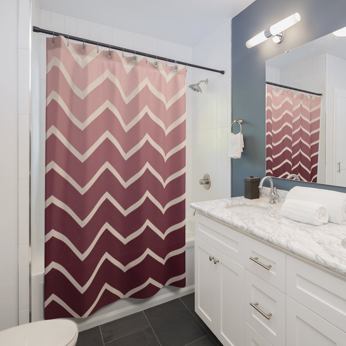 Blush to burgundy ombre chevrons with cream lines shower curtain beside a white vanity