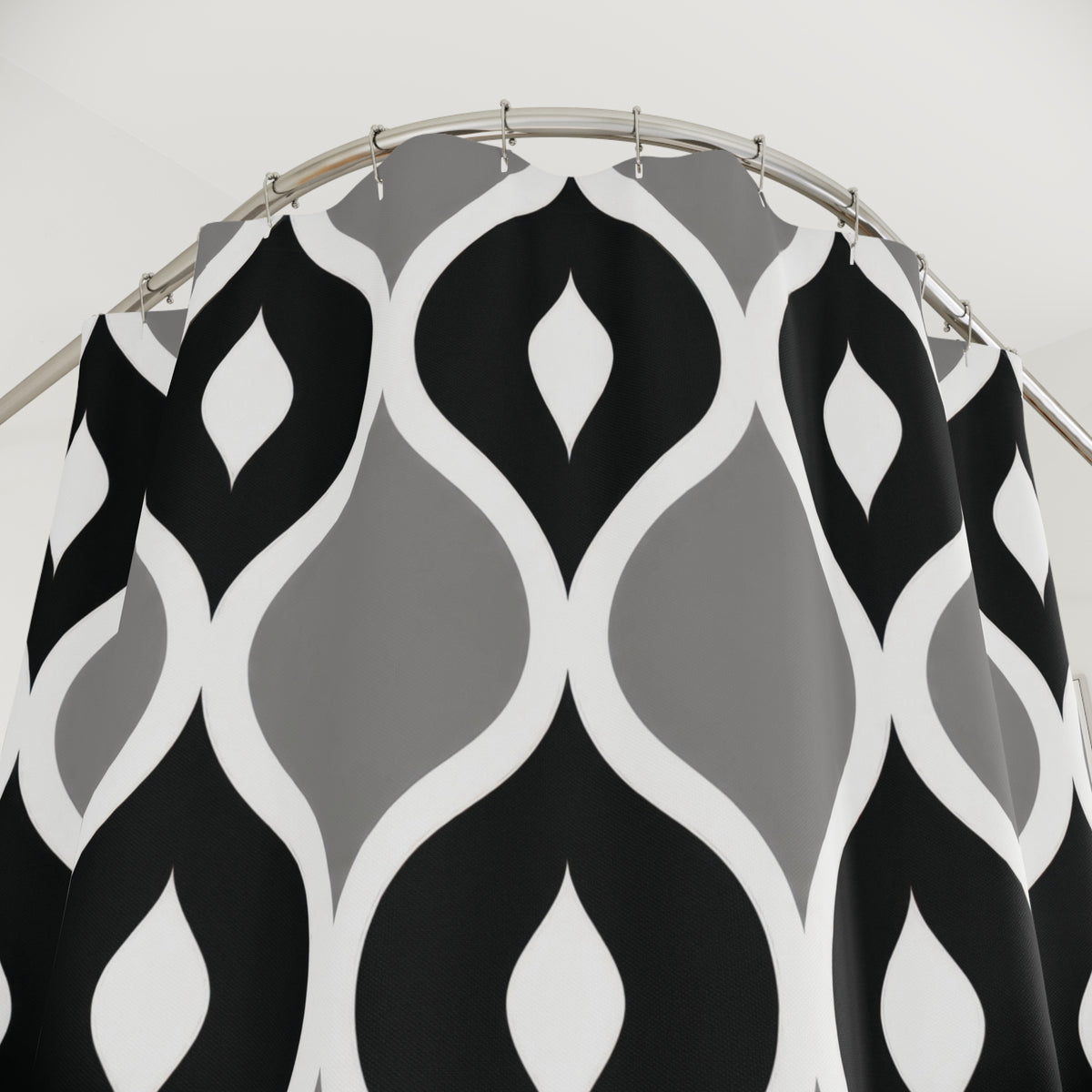 Black and gray ogees with white curved outlines shower curtain with close-up print, hooks, and folds