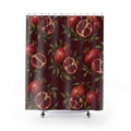 Red pomegranates with ruby seeds and green leaves on maroon shower curtain with full front view