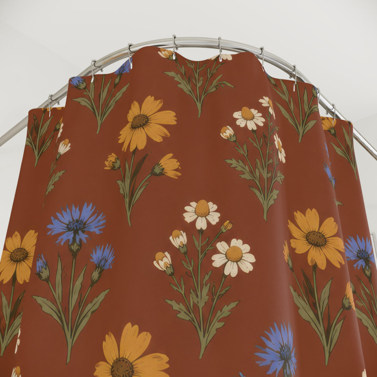 Ochre flowers, blue cornflowers and cream daisies on russet shower curtain with close-up print, hooks, and folds