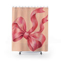 Oversized pink bow with curling tails on pale peach shower curtain with full front view