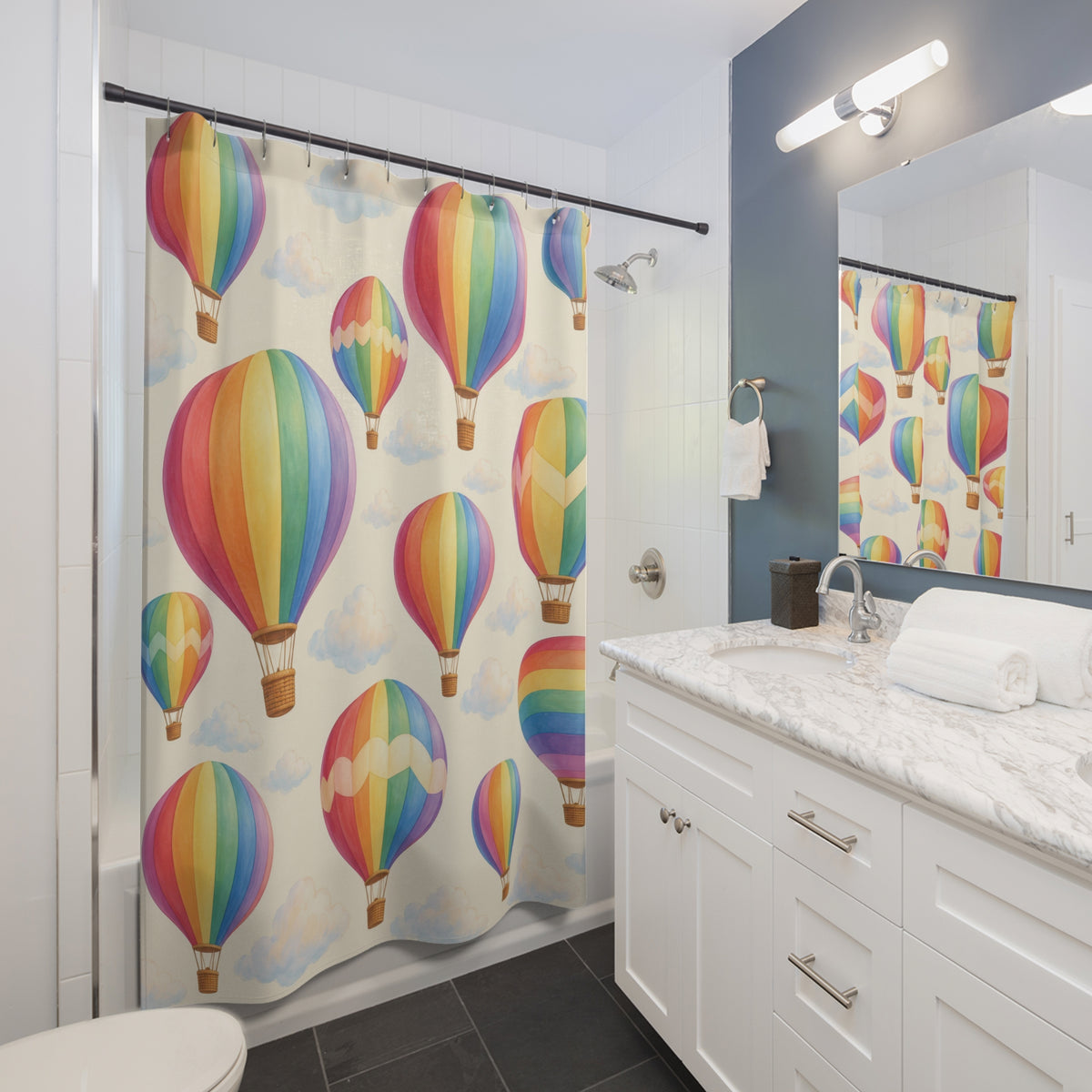Pastel rainbow hot air balloons and clouds on cream shower curtain beside a white vanity