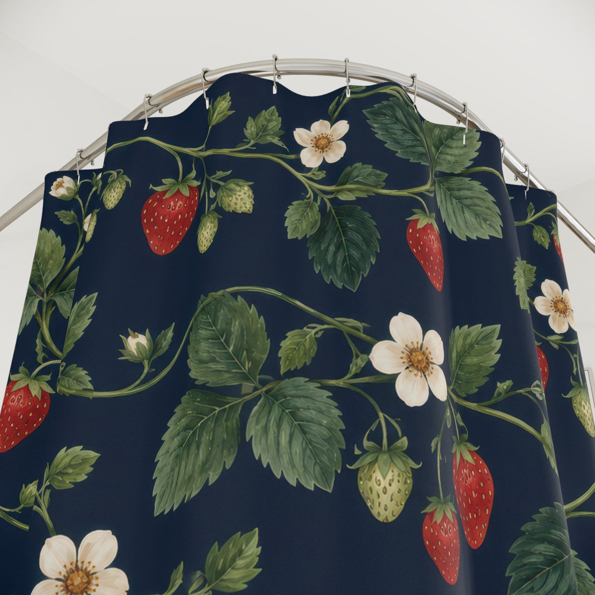 Red strawberries and ivory flowers on navy shower curtain with close-up print, hooks, and folds