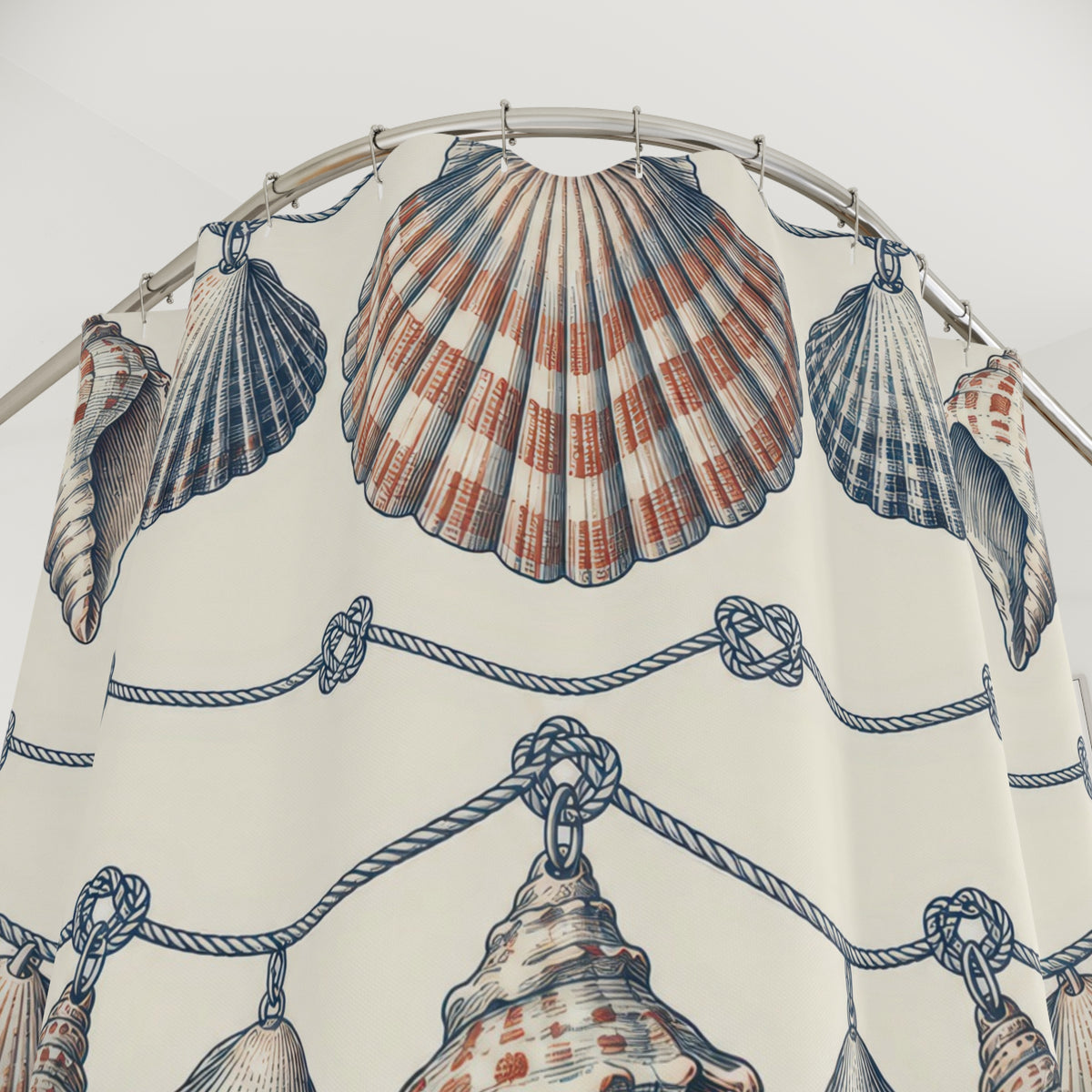 Navy and rust shell garlands with navy knots on ivory shower curtain with close-up print, hooks, and folds