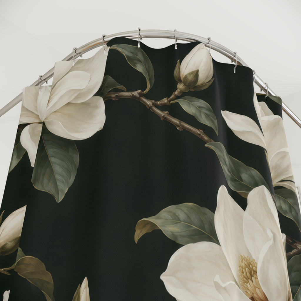 Creamy-white magnolias and olive leaves on dark green shower curtain with close-up print, hooks, and folds