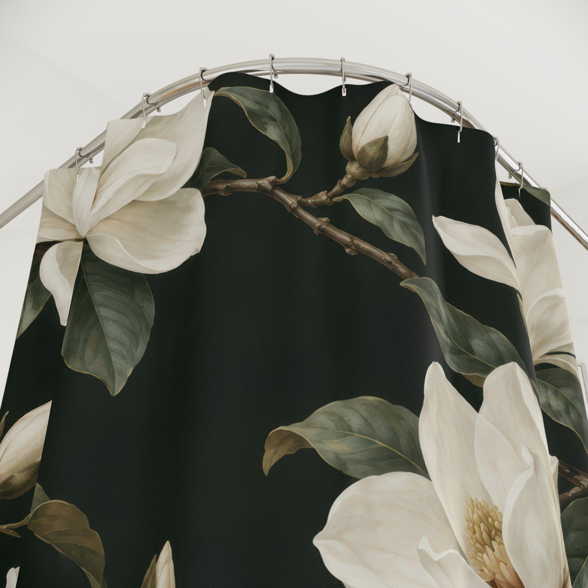 Creamy-white magnolias and olive leaves on dark green shower curtain with close-up print, hooks, and folds