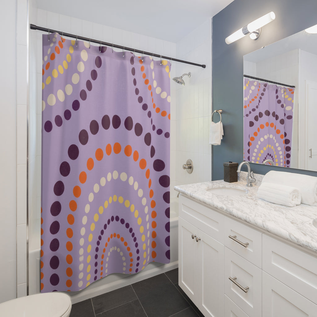 Purple polka dot arches with orange accents shower curtain beside a white vanity