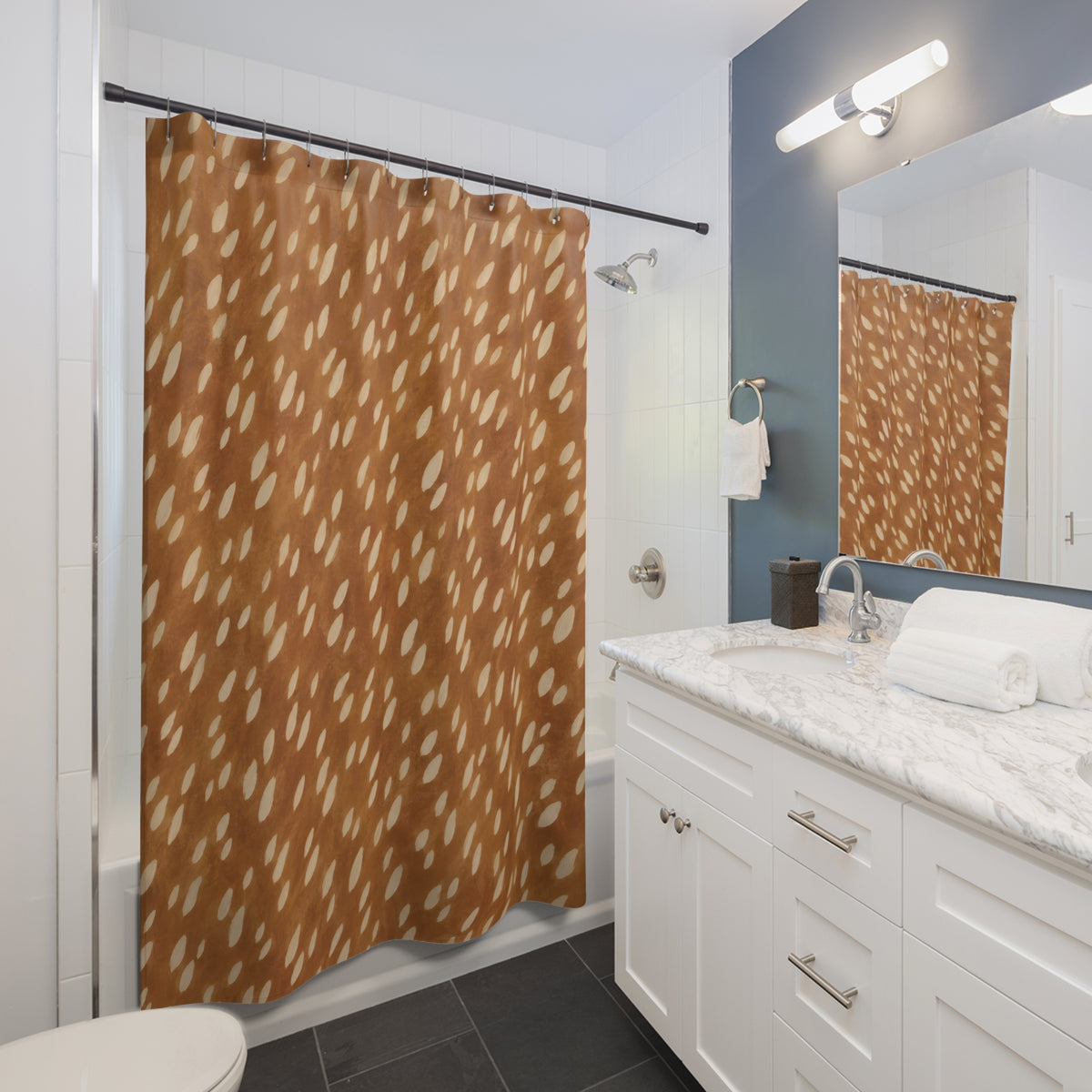Ivory fawn spots scattered over golden caramel brown shower curtain beside a white vanity