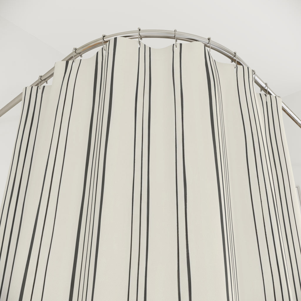Fine charcoal vertical line bundles on warm ivory shower curtain with close-up print, hooks, and folds