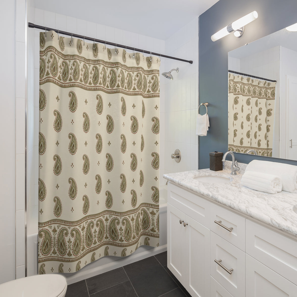 Sage paisley borders and rust outlines on cream shower curtain beside a white vanity