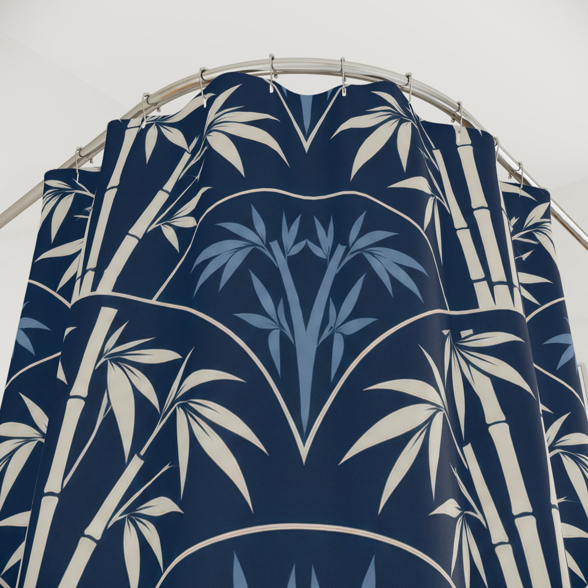 Ivory bamboo and blue leaves inside navy scallops shower curtain with close-up print, hooks, and folds