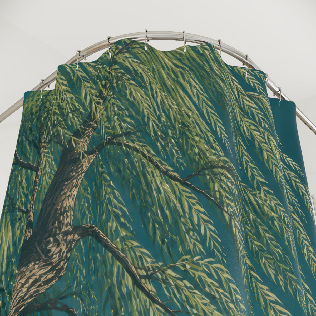Low-angle willow tree canopy against a teal sky shower curtain with close-up print, hooks, and folds
