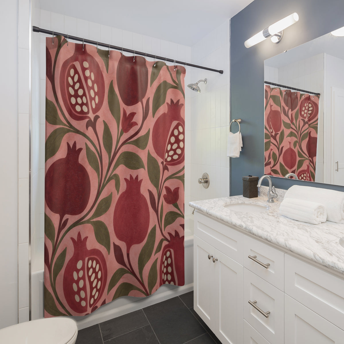 Pink and burgundy pomegranates with olive leaves on rose shower curtain beside a white vanity