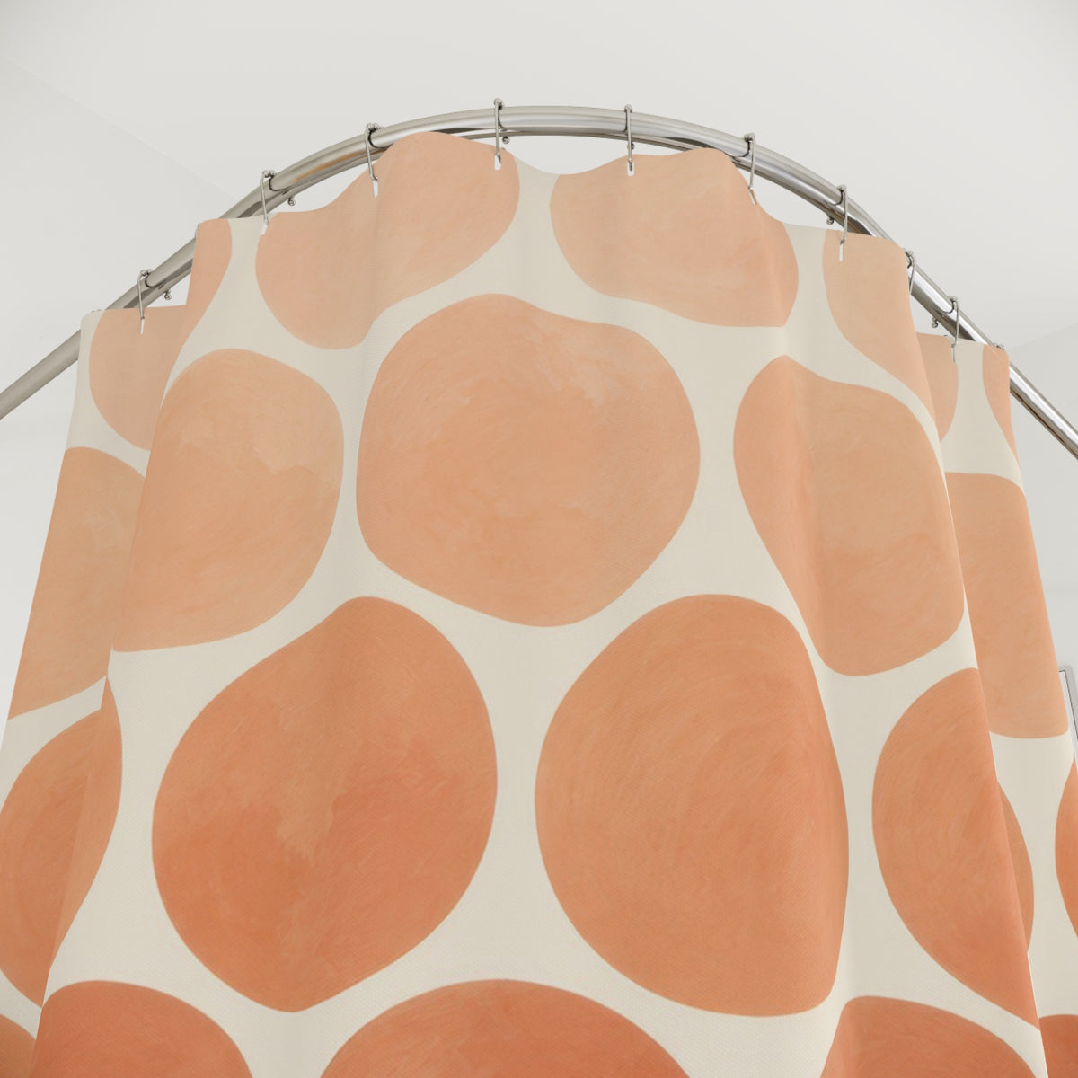 Peach to terracotta ombre dots on ivory shower curtain with close-up print, hooks, and folds