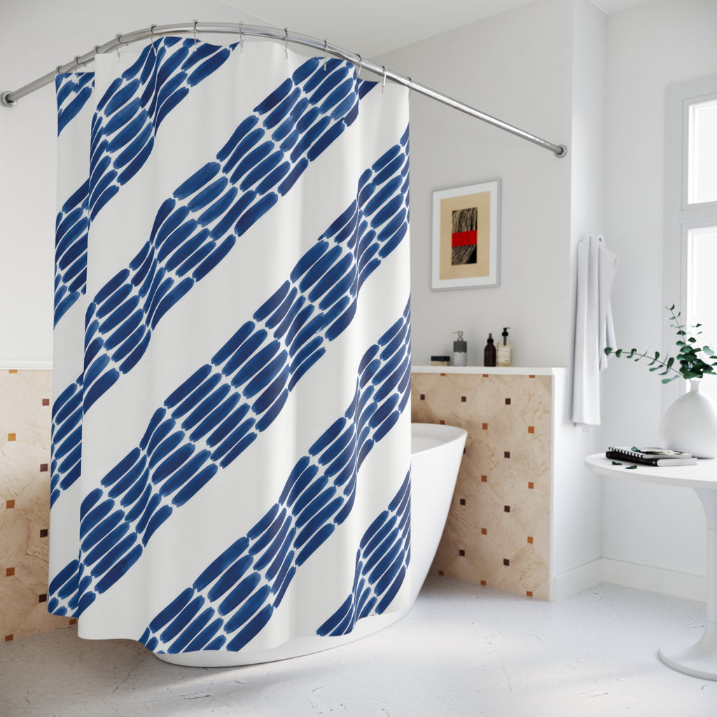 Diagonal indigo ink dashes and broad white stripes shower curtain beside a freestanding tub