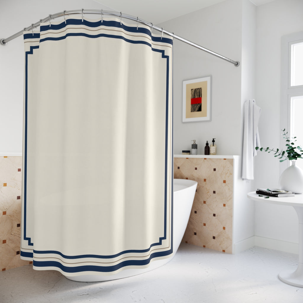 Navy stepped borders around an ivory center shower curtain beside a freestanding tub