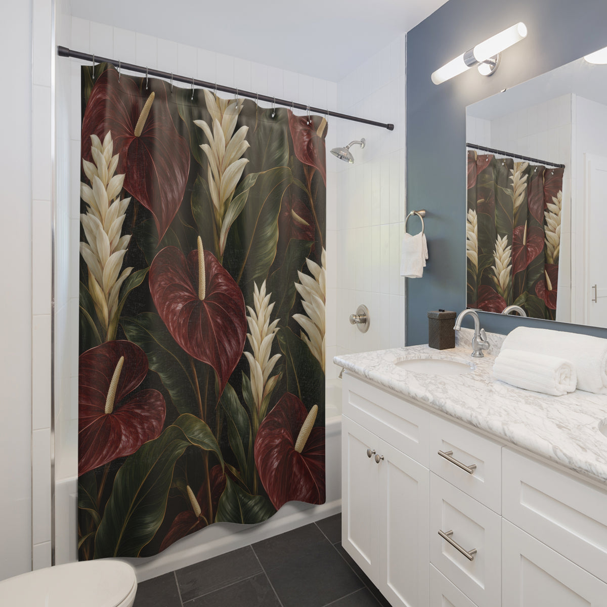 Burgundy anthuriums and cream flowers on black shower curtain beside a white vanity