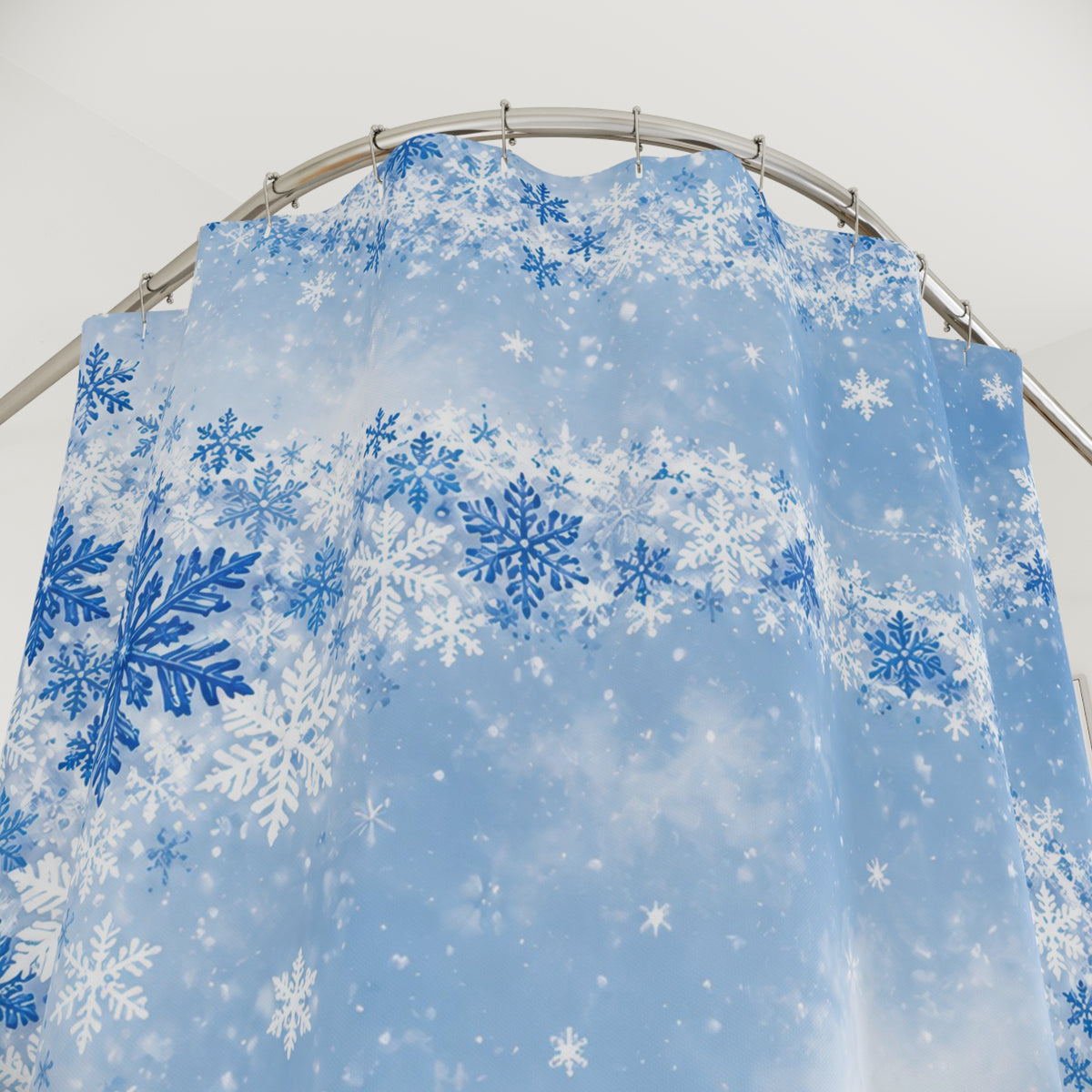 Blue orbital snowfall shower curtain with close-up print, hooks, and folds