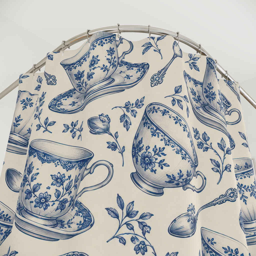 Blue floral teacups and saucers on cream shower curtain with close-up print, hooks, and folds