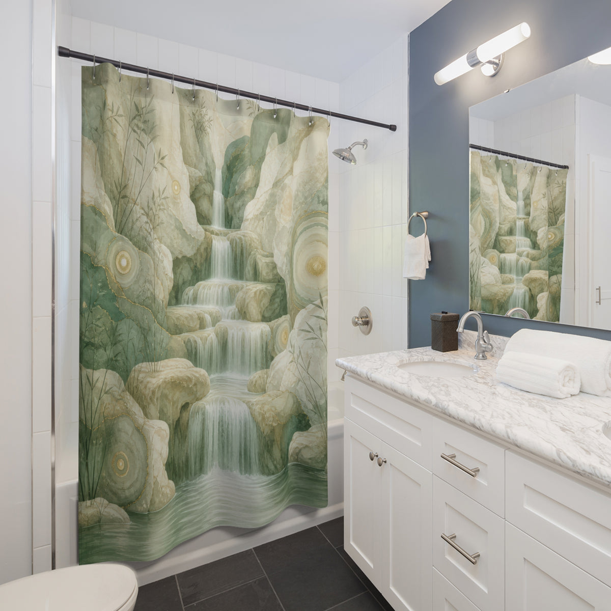 Luminous waterfall descending through layered sage mineral cliffs shower curtain beside a white vanity