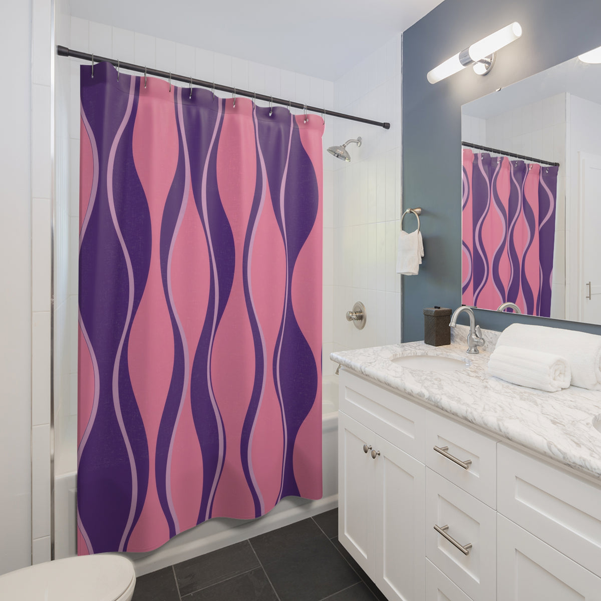 Pink and grape purple hourglass stripes with lilac lines shower curtain beside a white vanity