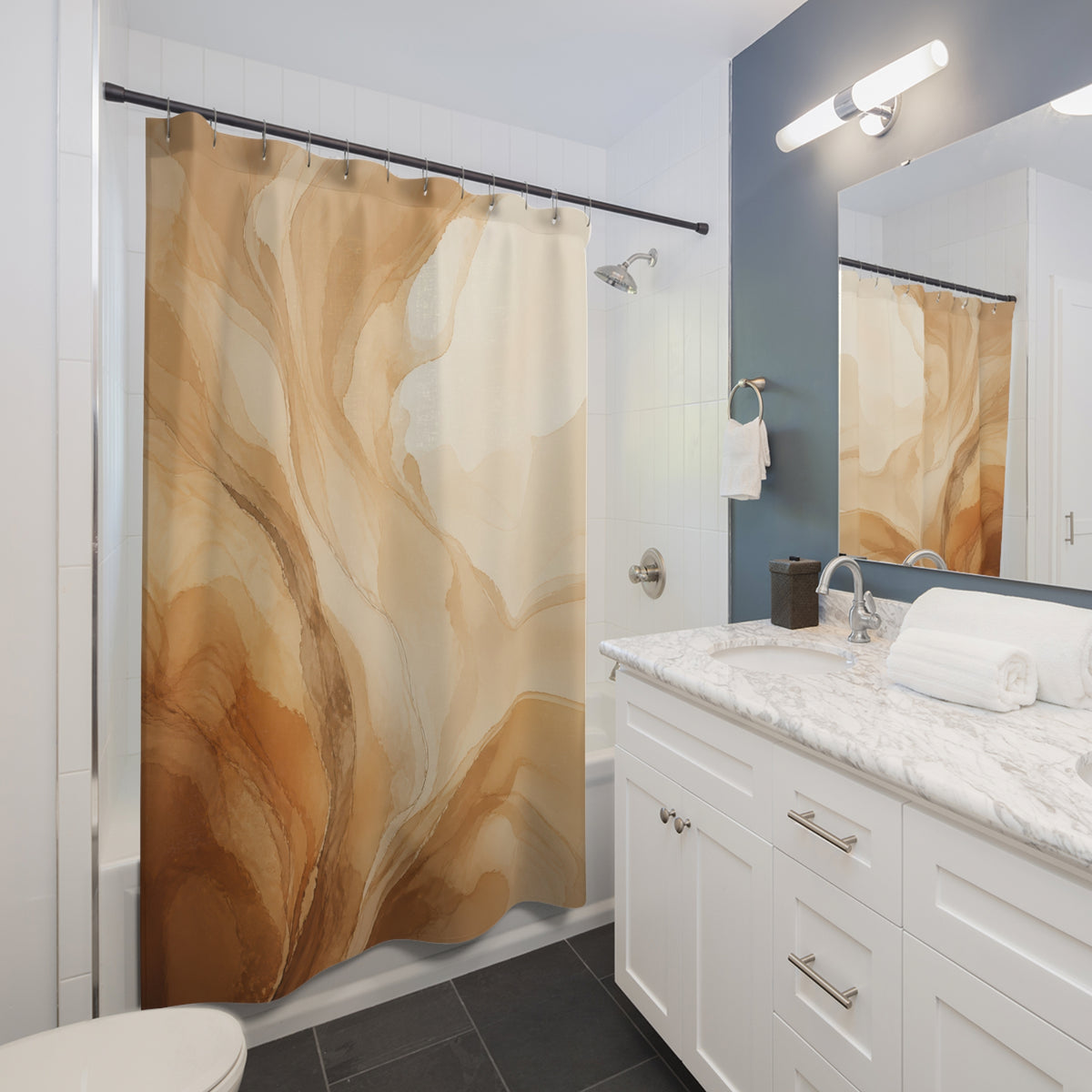 Sweeping tan caramel and cream mineral plume abstraction shower curtain beside a white vanity