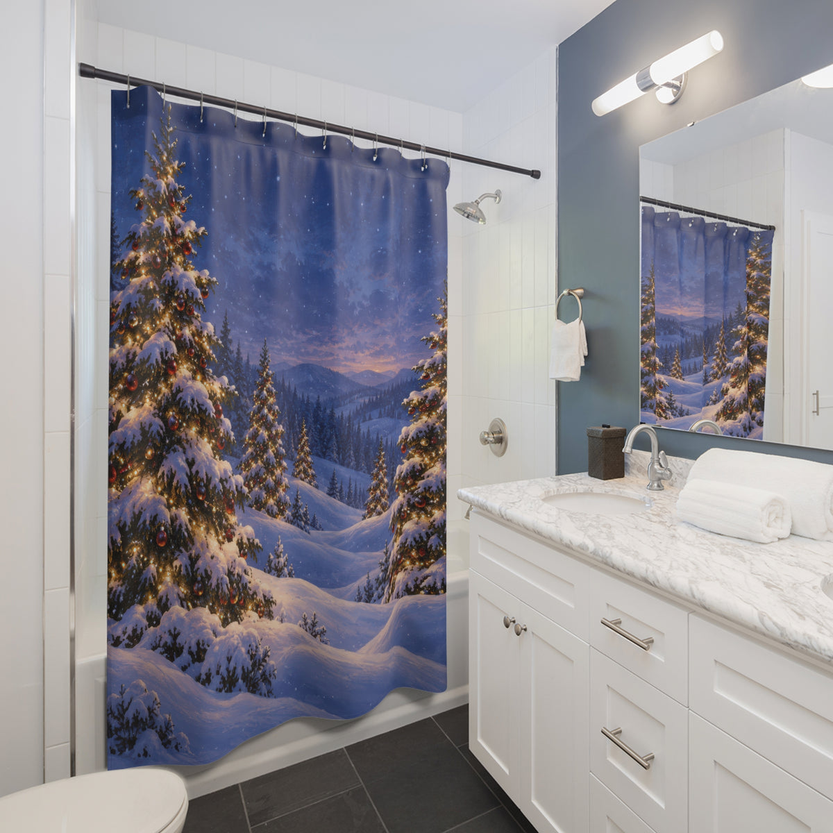 Snowy Christmas trees with warm lights in a blue winter valley shower curtain beside a white vanity