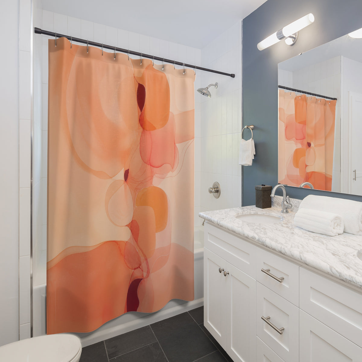Peachy translucent apricot abstract shapes shower curtain beside a white vanity
