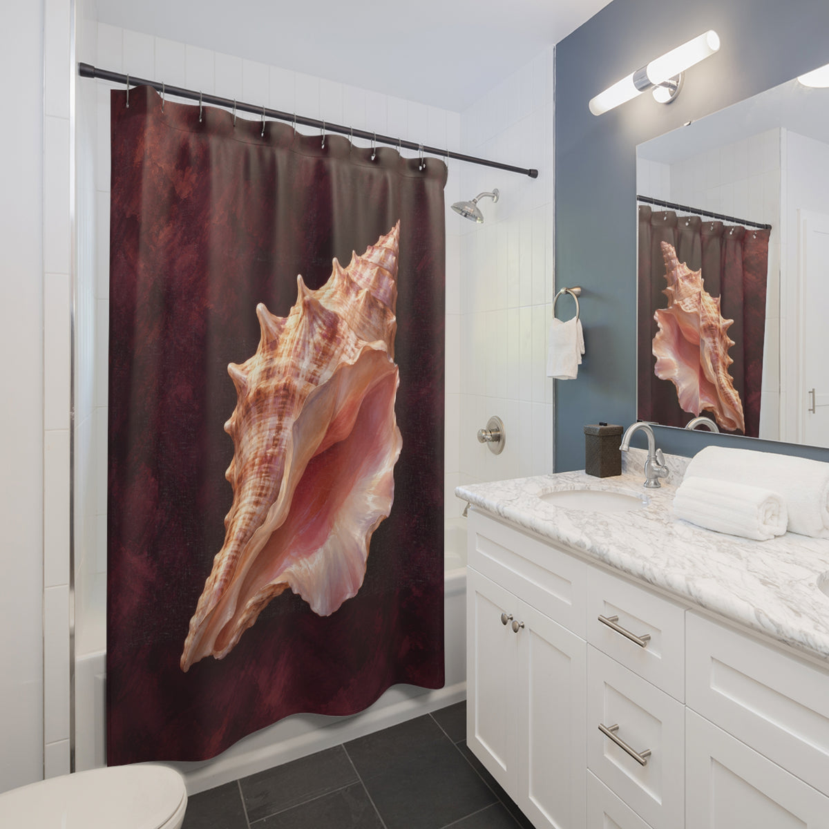 Peach conch shell with a pink opening on deep plum shower curtain beside a white vanity