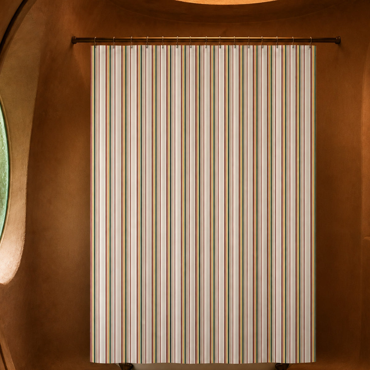 Boho multi stripe shower curtain in a saffron-lit rammed earth designer bathroom