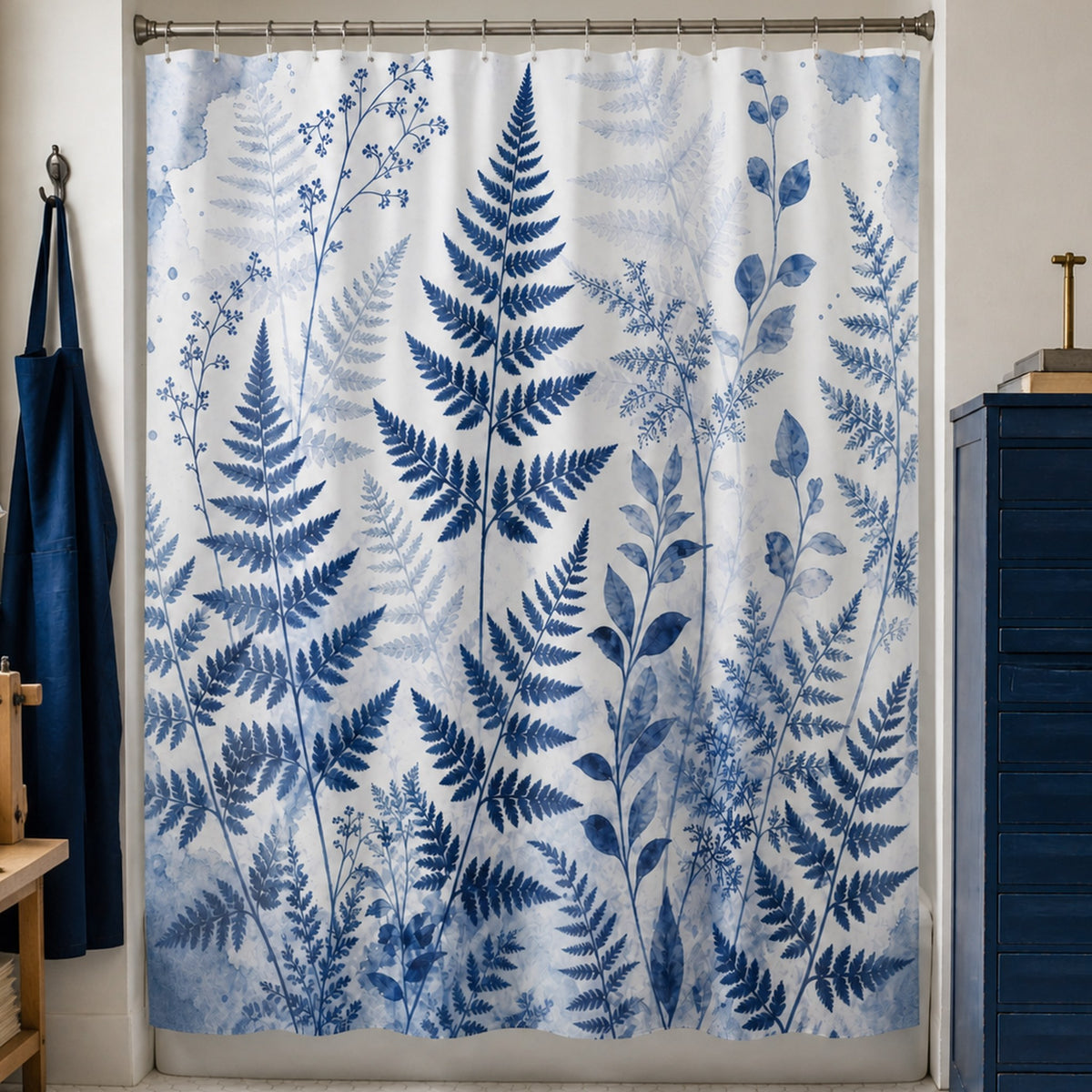 Blue watercolor fern shower curtain in a cyanotype book conservator studio bathroom with cobalt drawers and indigo apron