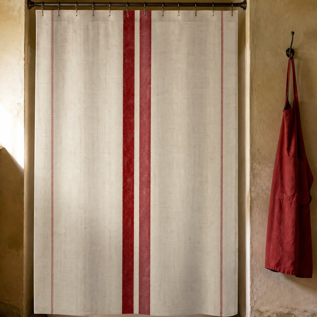 French red stripe shower curtain in a sunwashed Provence furniture restorer washroom with plaster and oak