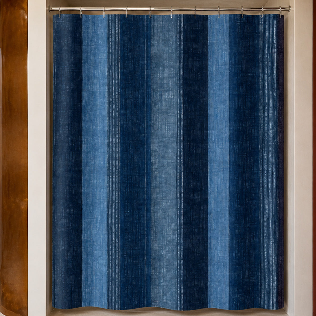 Navy denim stripe shower curtain in a luxury bathroom with amber resin, smoky blue glass and rust cabinetry